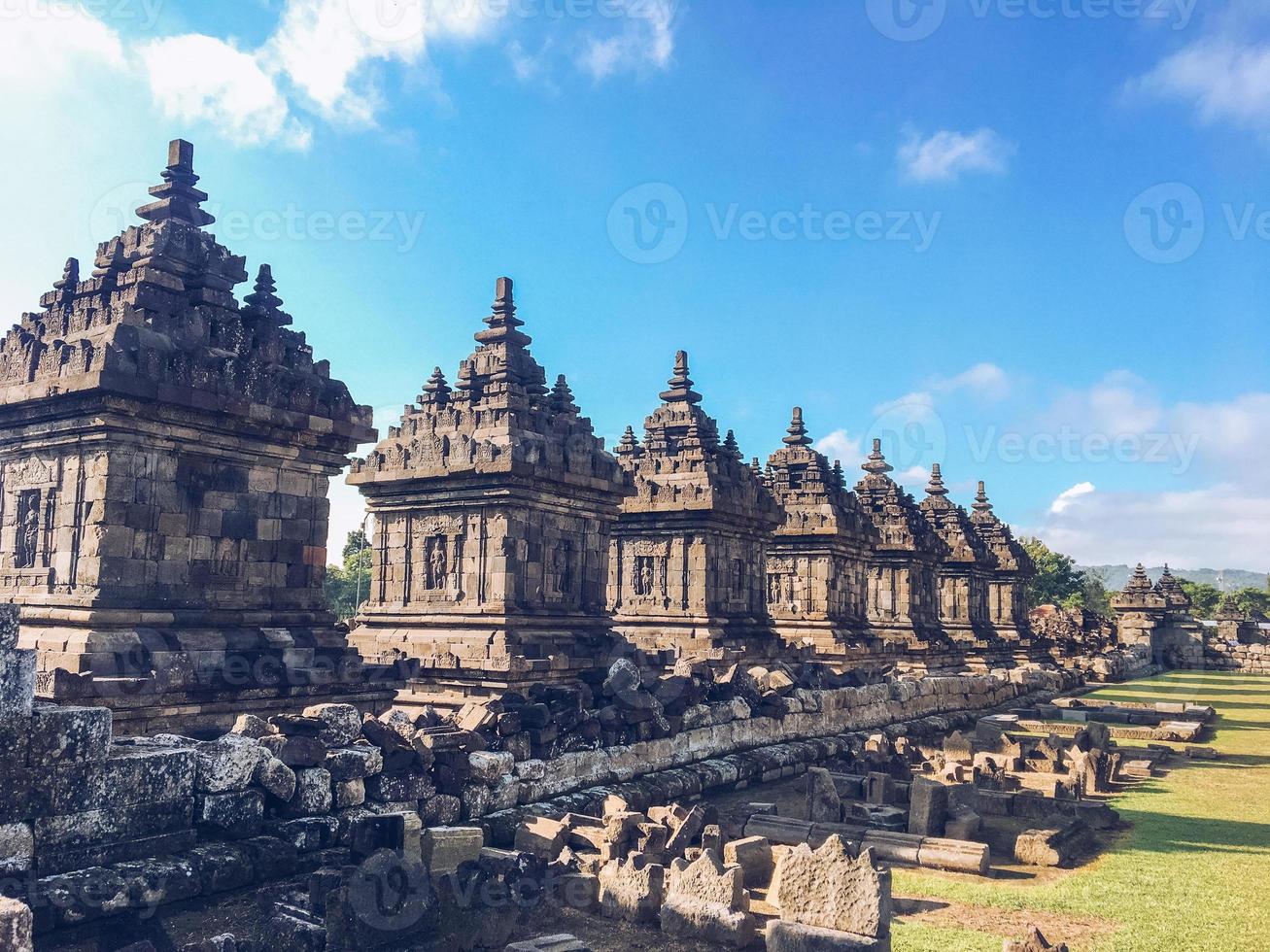 Many small Temple in Plaosan Complex temple with blue sky and sunny sun background. One of the javanese Buddhist temples located in Prambanan, Klaten, Central Java, Indonesia. photo