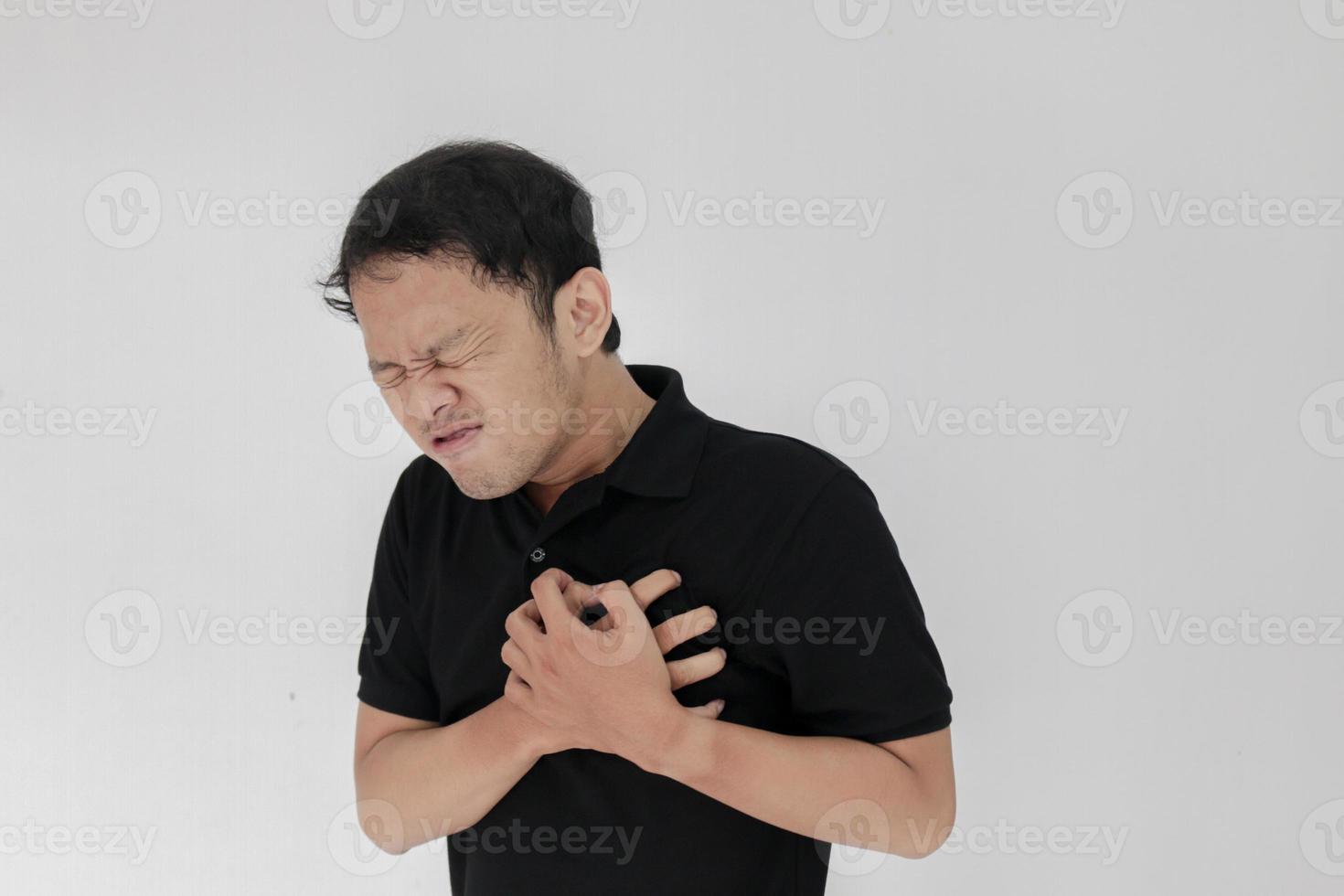 Heart attack or broken heart of young asian man with hurt emotion wear black shirt photo