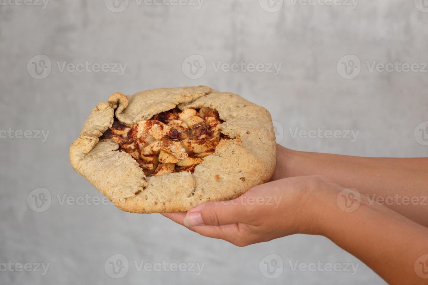 biscuits with apples and cinnamon in the hands of women photo