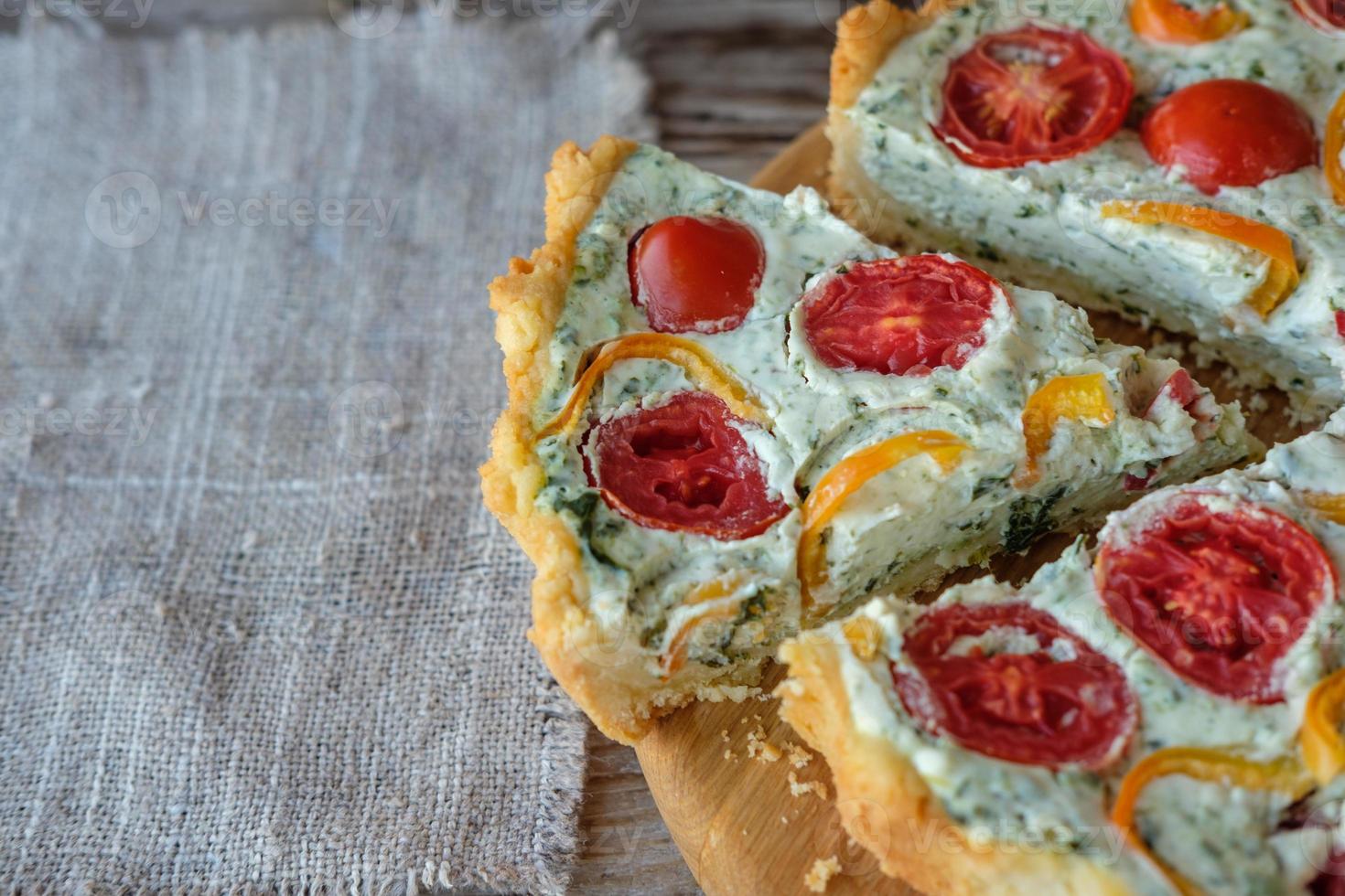 French quiche with tomatoes and pepper and broccoli on wooden Board photo