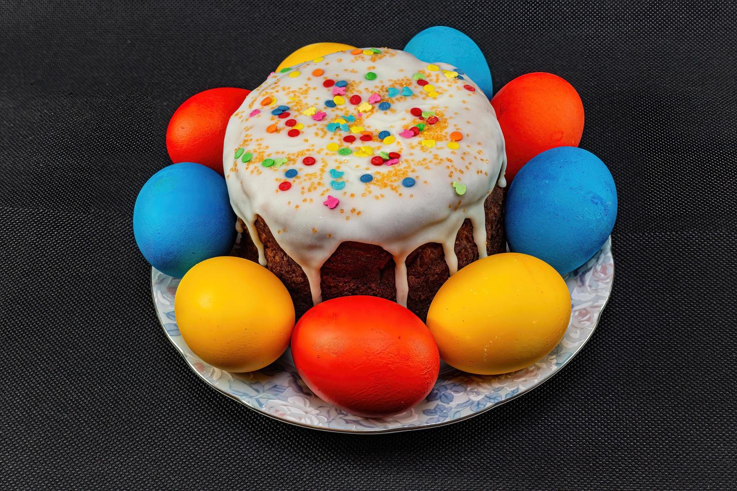 Festive cake and beautiful eggs for Holy Easter on a black background. photo