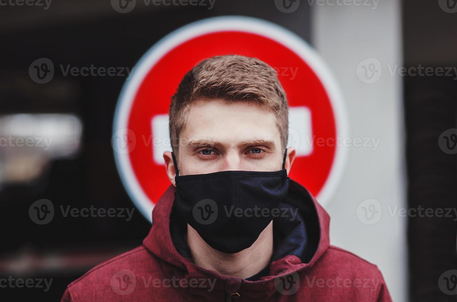 Man in protective mask in city street photo