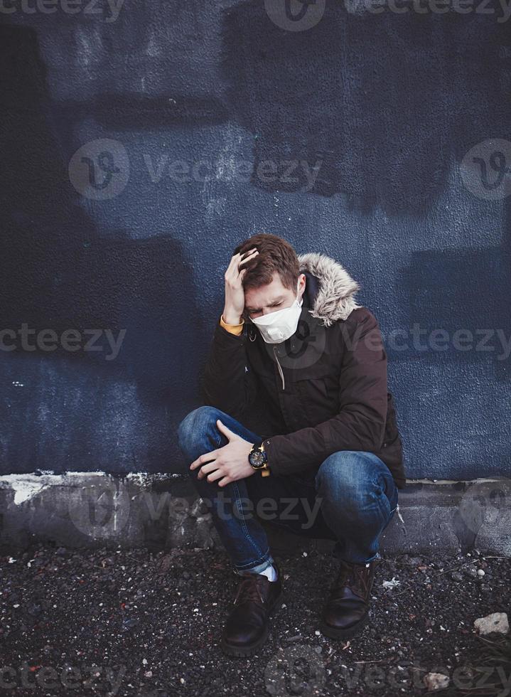 sick man with a coronavirus sits in a mask photo