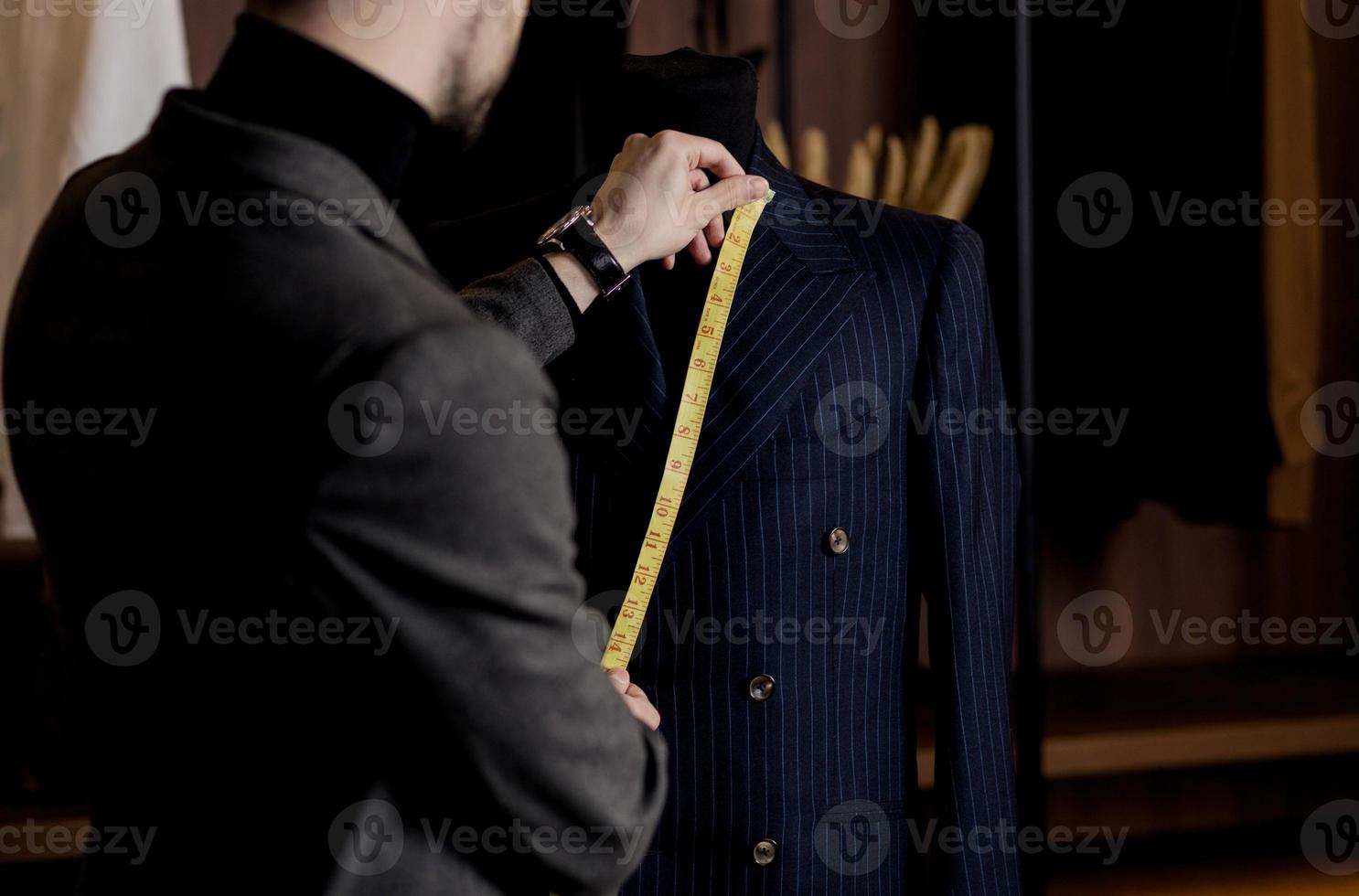 tailor takes measurements photo