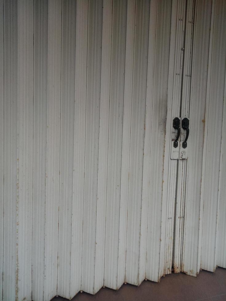 Dull and rusty white folding door photo