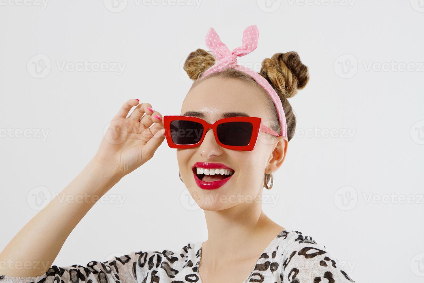 Happy woman face closeup. Summer fashion and accessories. Closeup female portrait in red sunglesses and colorful makeup. Isolated on white background. Copy space photo