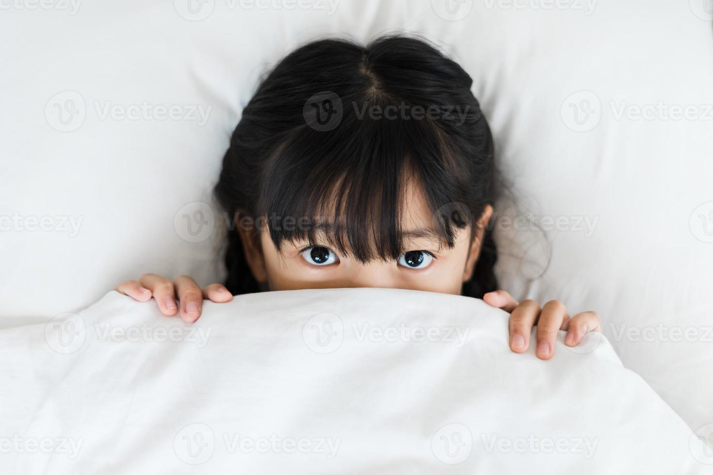 portrait of girl lying in bed photo