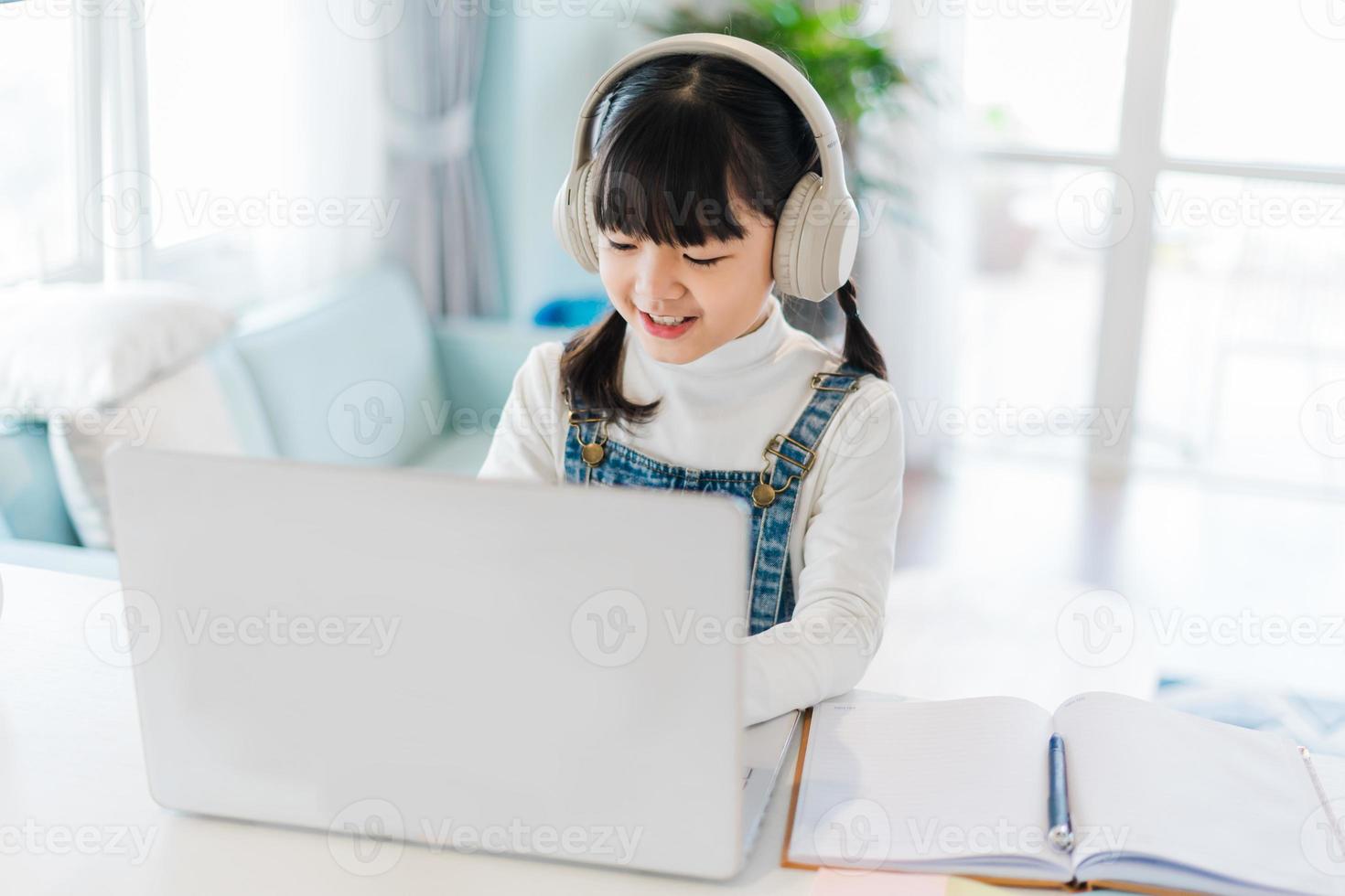 Portrait of a girl studying online at home photo