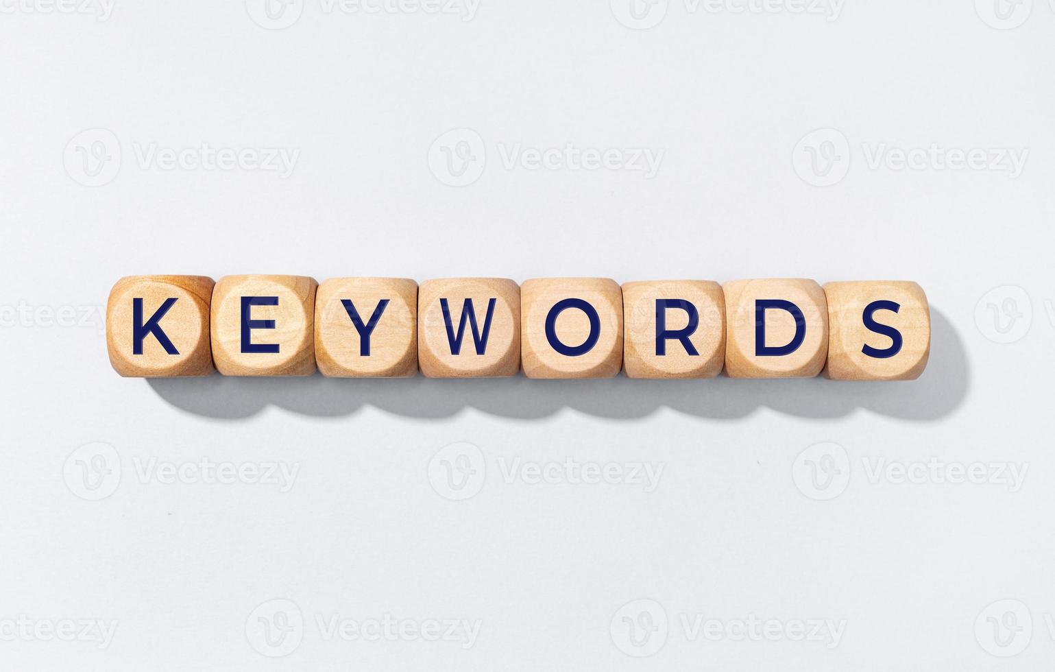 Keywords word on wooden blocks isolated on gray background photo