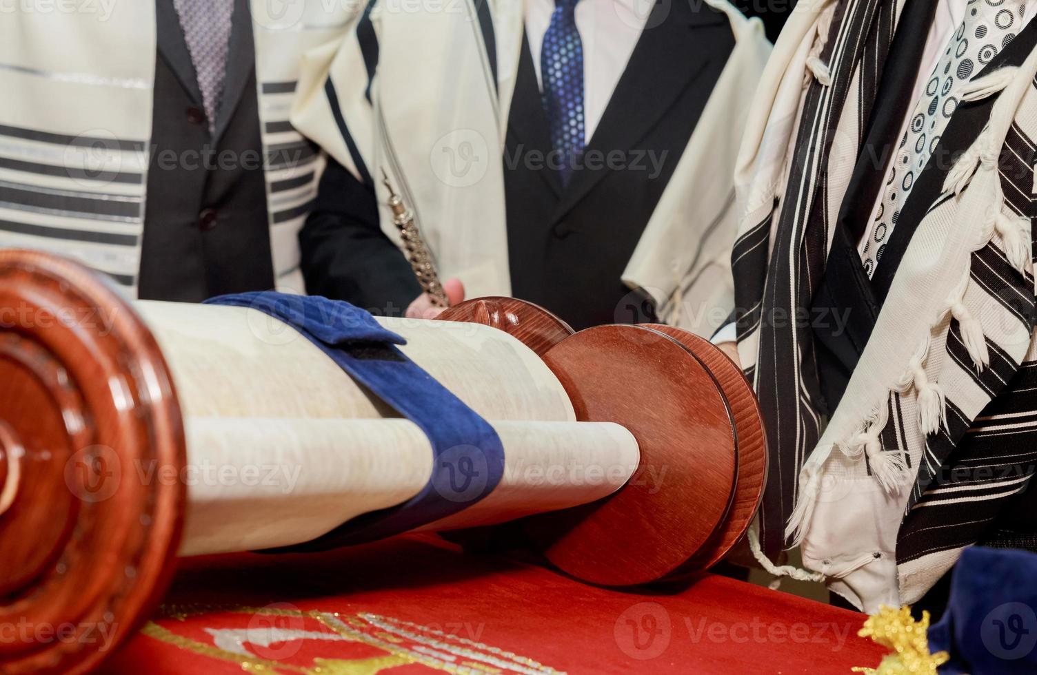Hand of boy reading the Jewish Torah at Bar Mitzvah photo