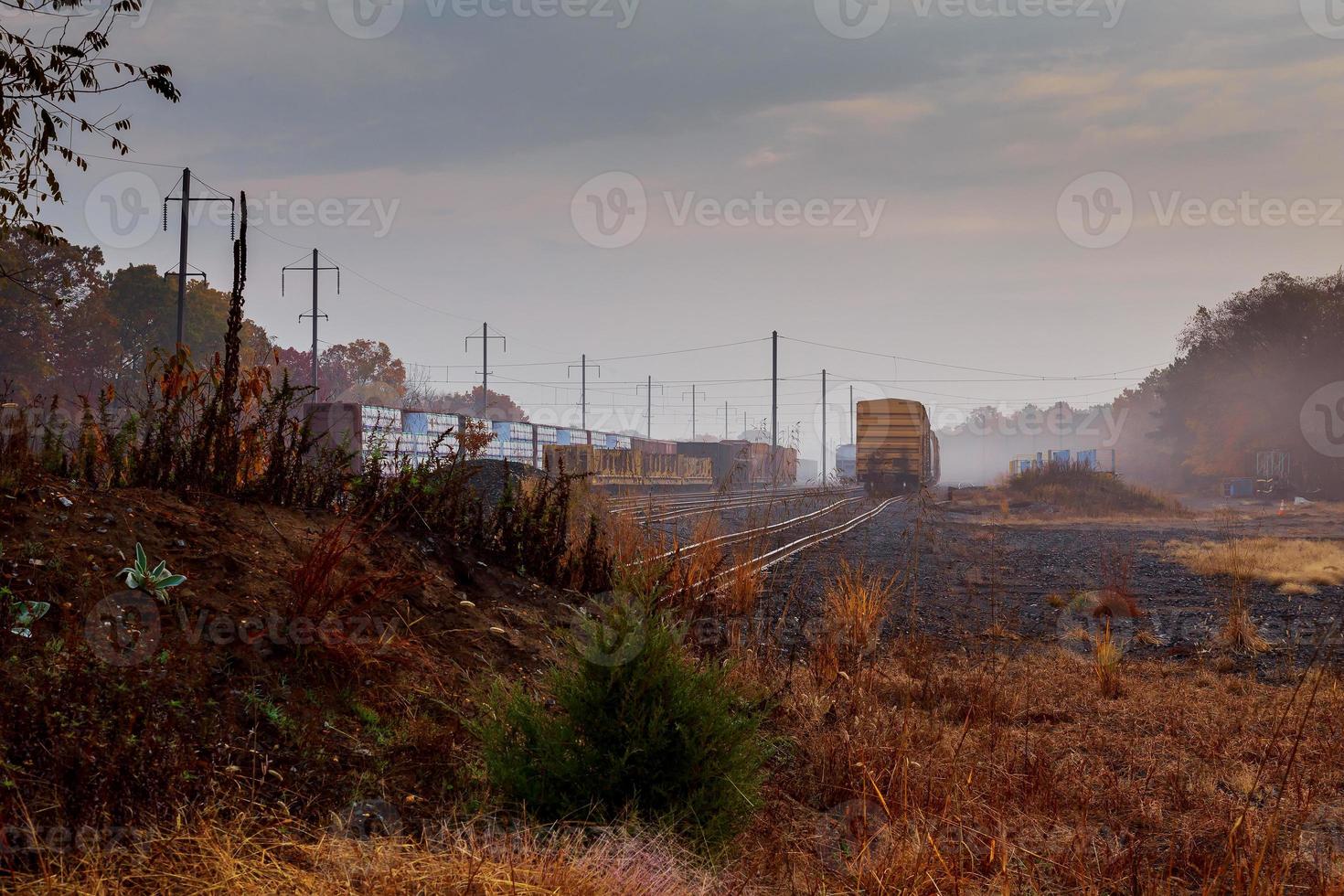 Railroad in the forest on a foggy autumn day. photo