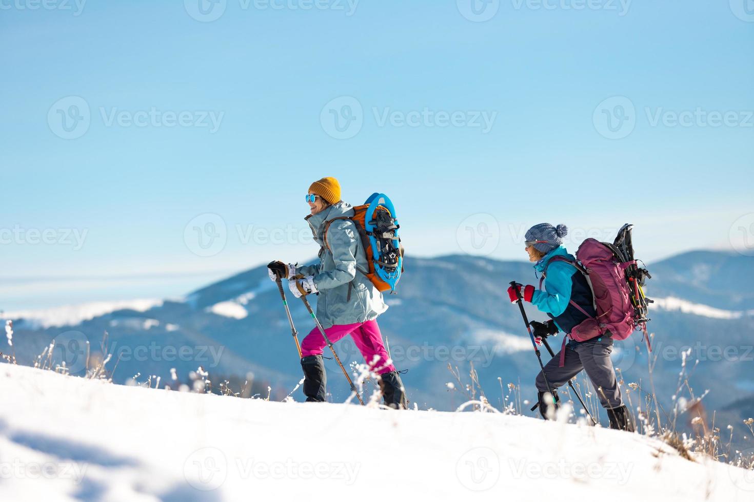 Two people in the mountains in winter photo