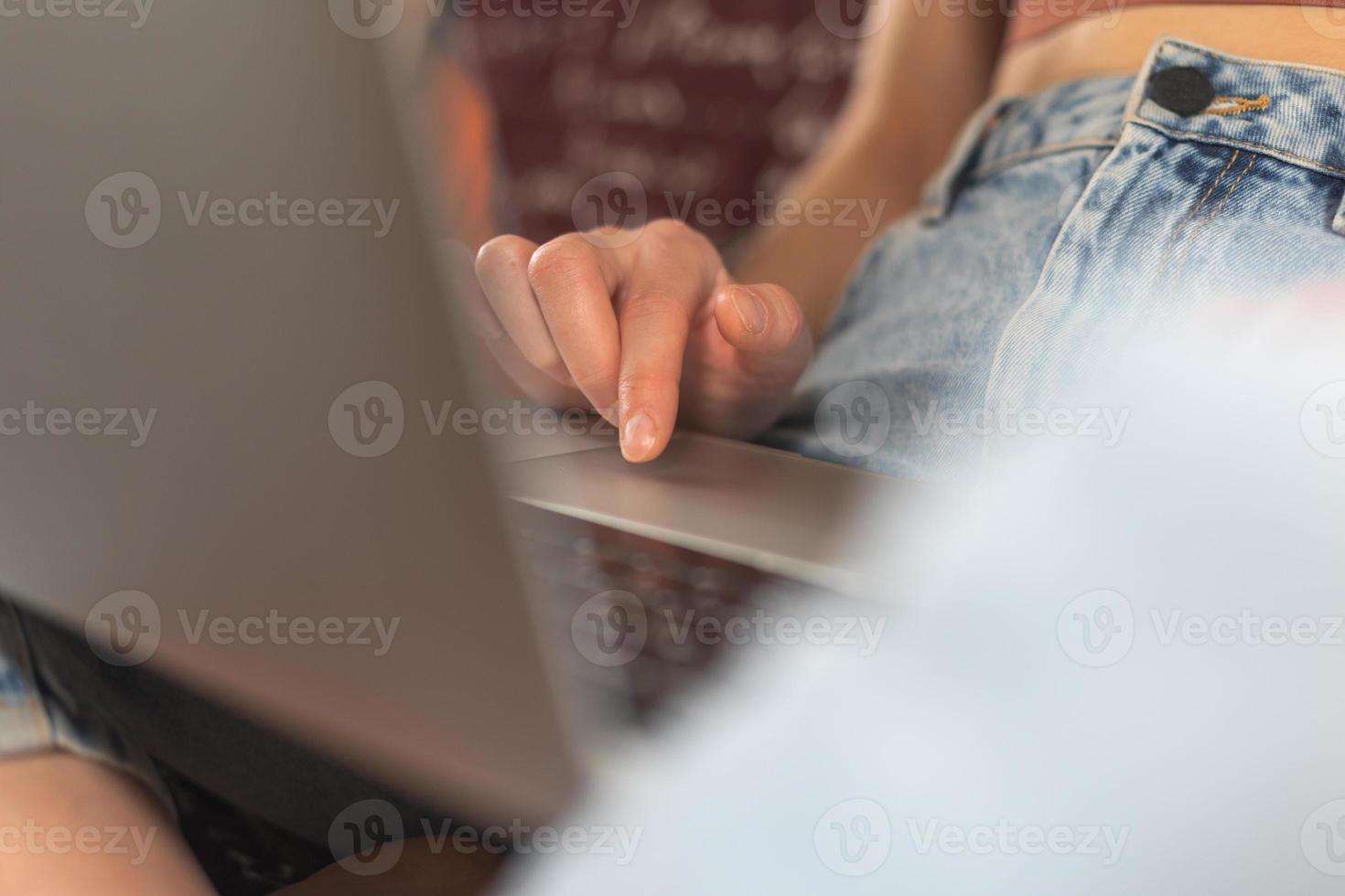 Female hands on the keyboard, the girl works at a laptop and types photo