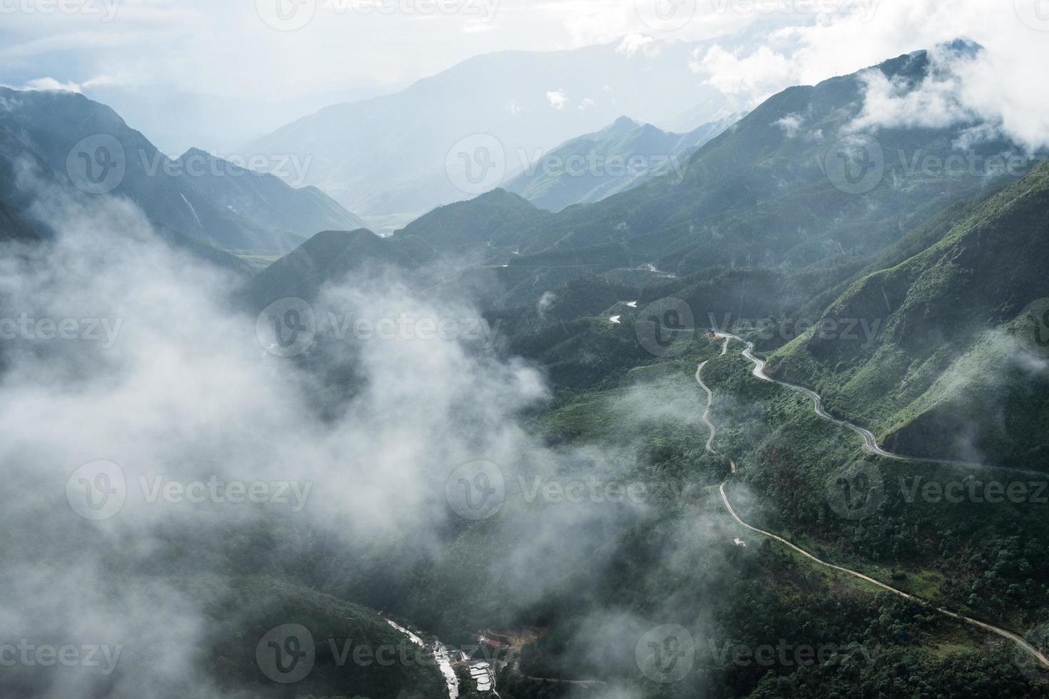 Scenery of Tram Ton Pass or O Quy Ho Pass is mountain pass winding in valley with foggy at Sapa, Northwest Vietnam photo