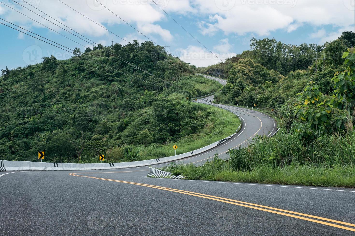 Winding road shaped like 3 on top of mountain in tropical rainforest at Nan province photo