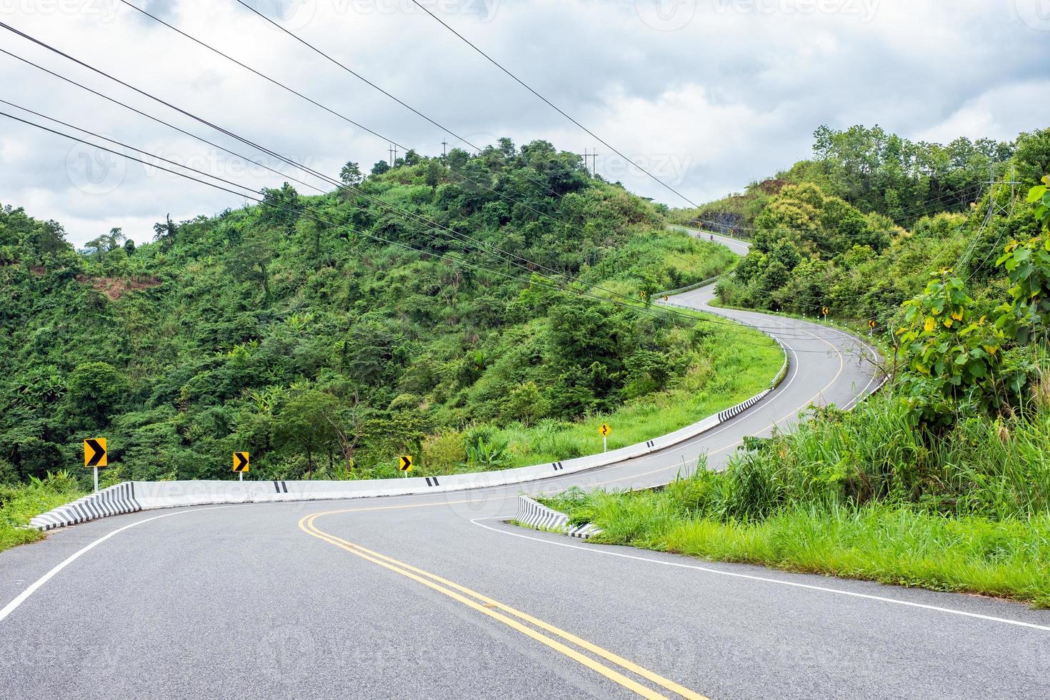 Asphalt road curved on hill photo