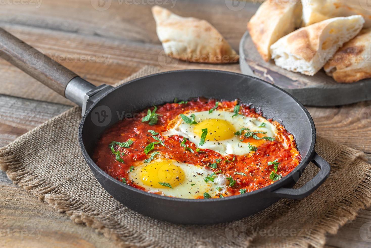 Shakshouka served in a frying pan photo