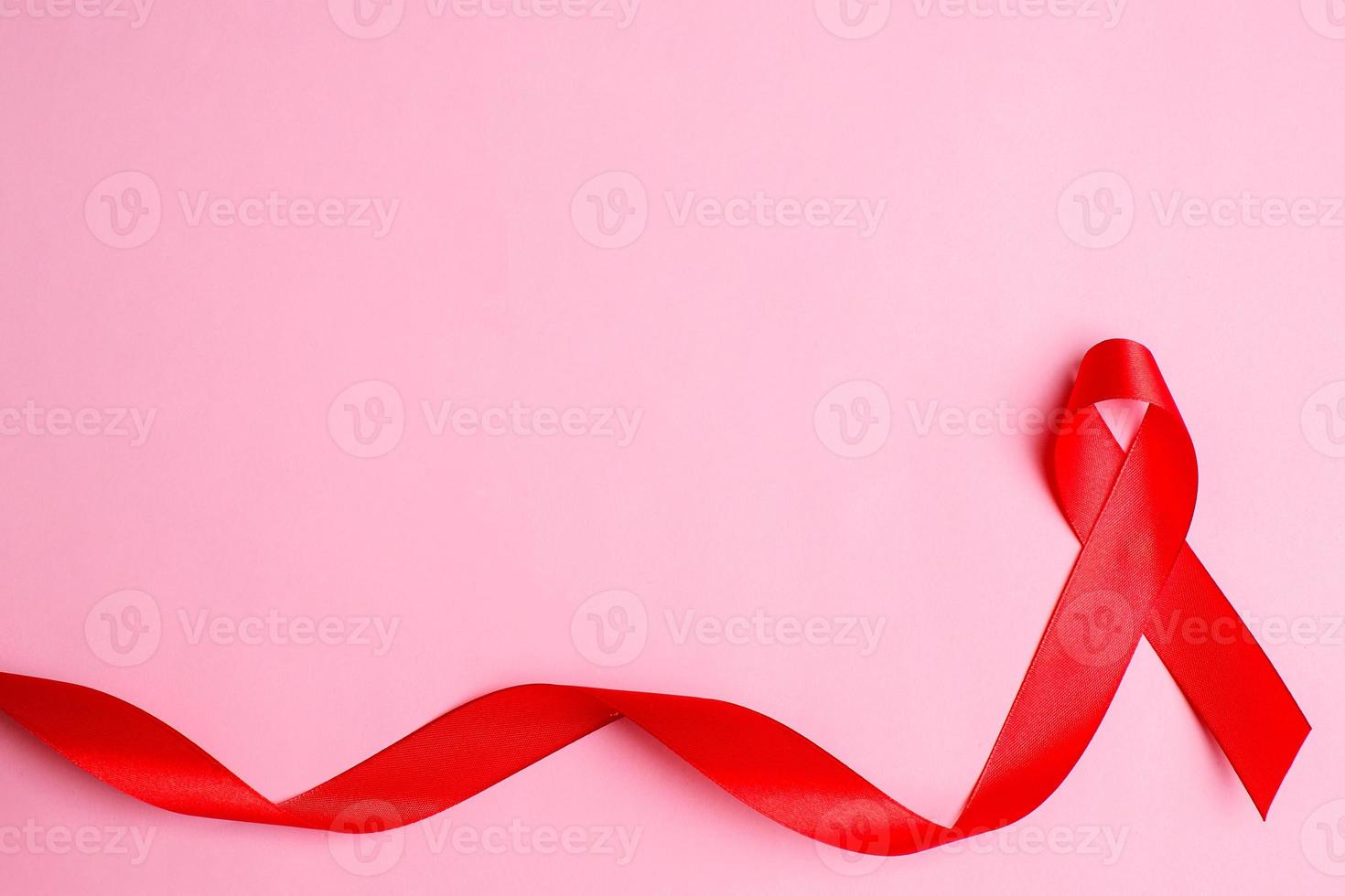 Hands holding red ribbon, hiv awareness concept photo
