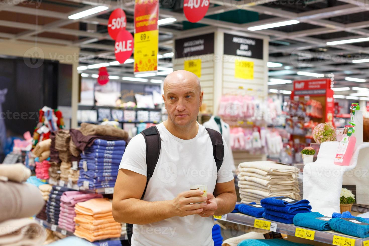 A man during a sale chooses towels photo