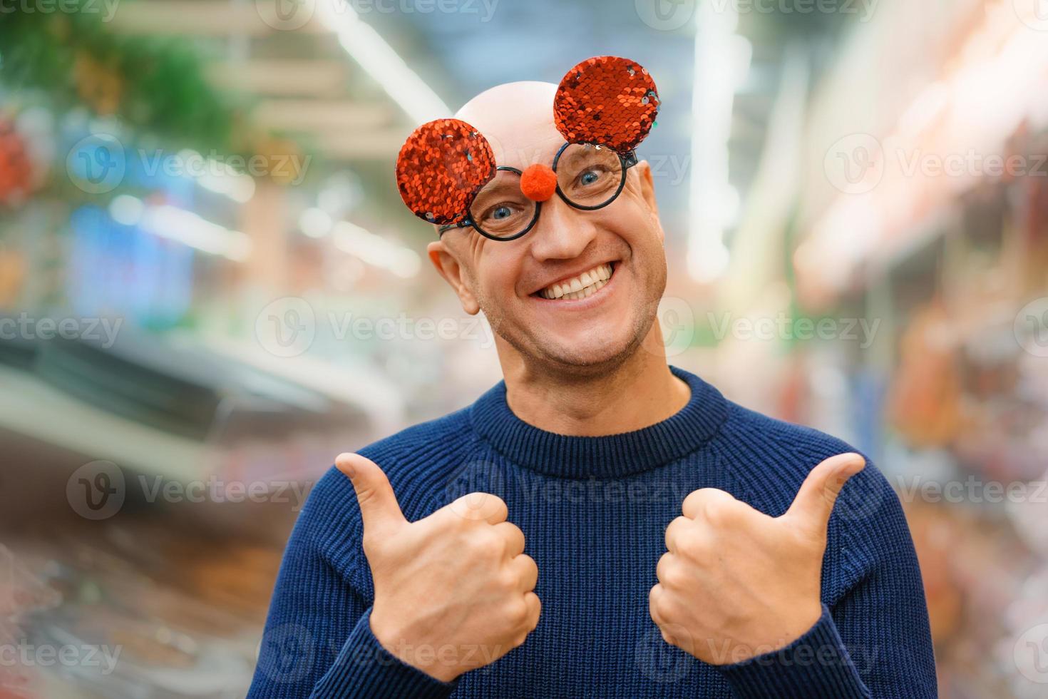 Funny bald man in carnival glasses photo