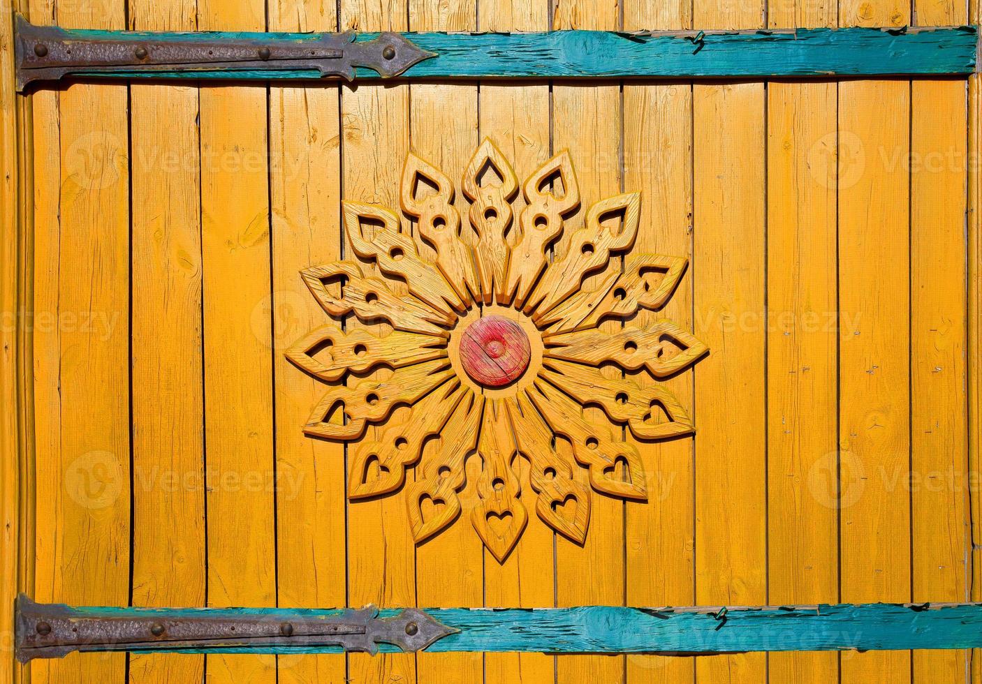 gate of rural house with wooden carving in Russian village. photo