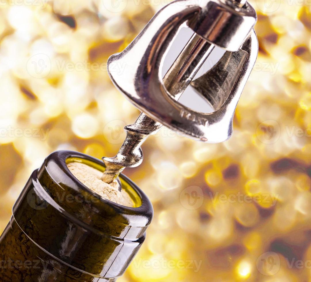 The Opening a wine bottle with a cork screw photo