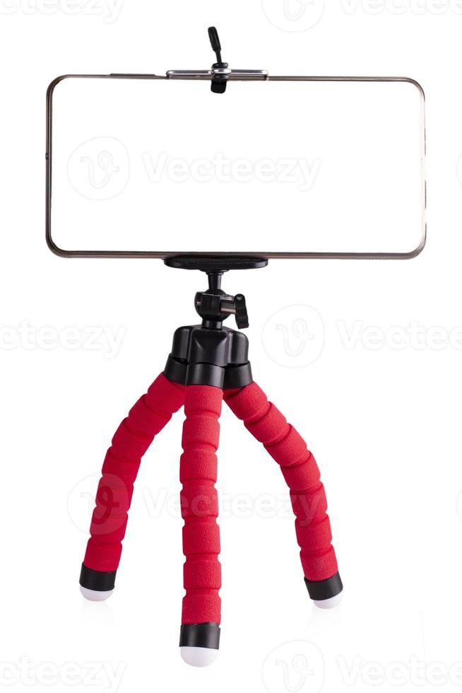 The Smart Phone isolated on red tripod in white background photo