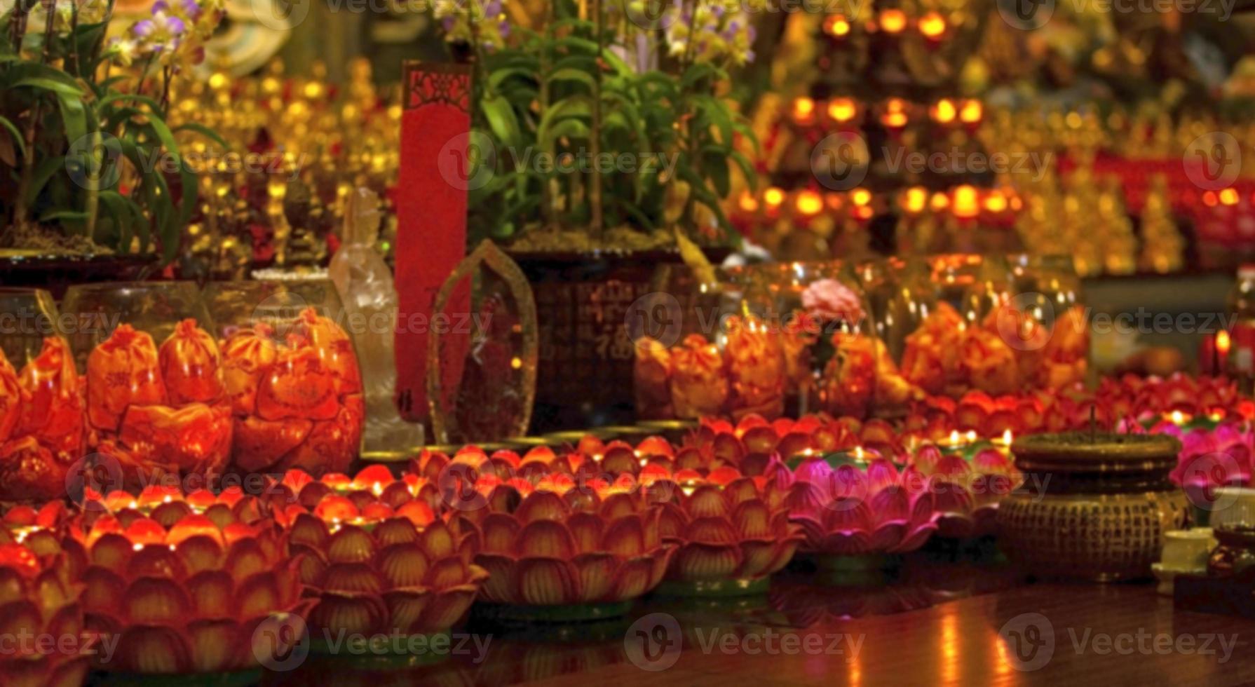 The blurred image of Red candle on table in Chinese Buddhist temple for renew life or navigate life in Chinese temple photo