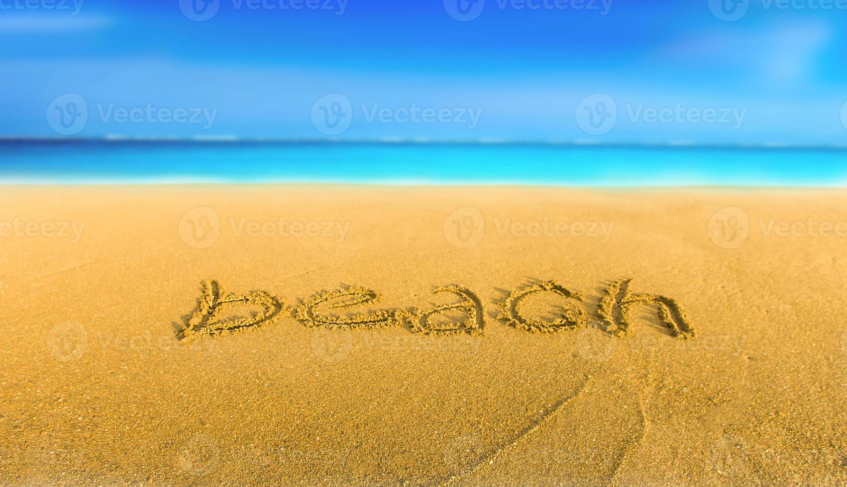 The yellow sand on the beach blue sea and the inscription beach photo