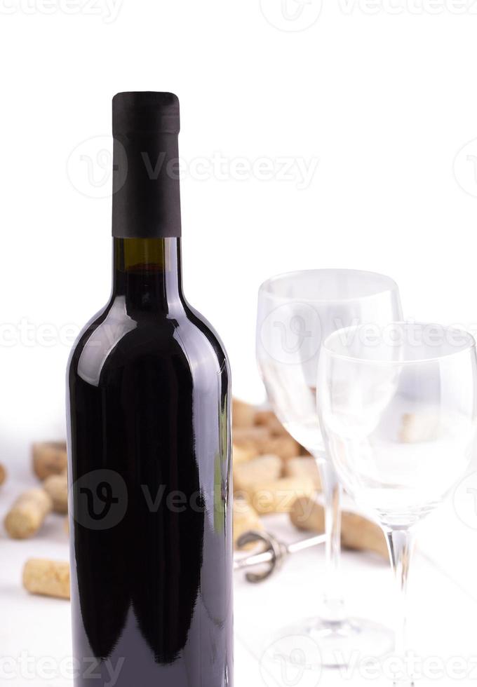 The Red wine glasses, bottle and corks. Isolated on white background photo