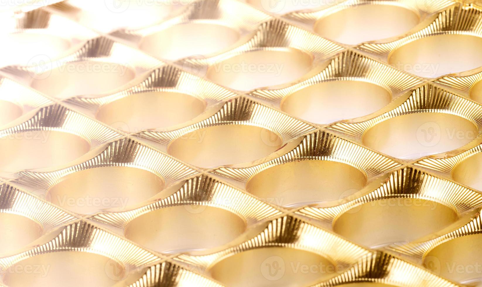 The shiny gold plastic background as texture of the empy candy box photo