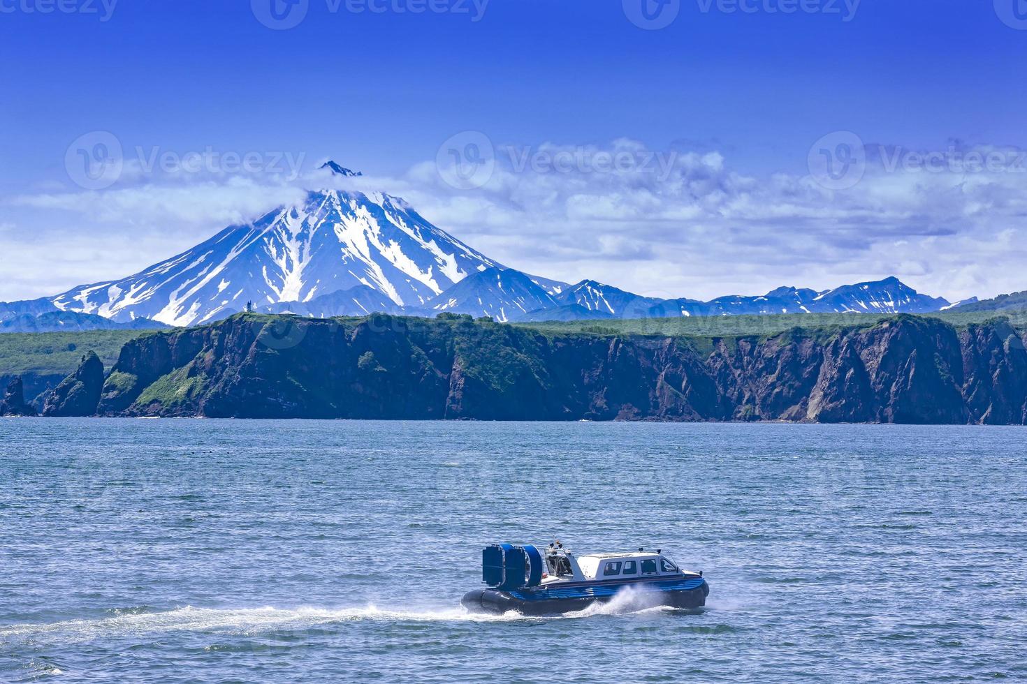 The Hovercraft on Pasific ocean in kamchatka Peninsula on the background volcano photo