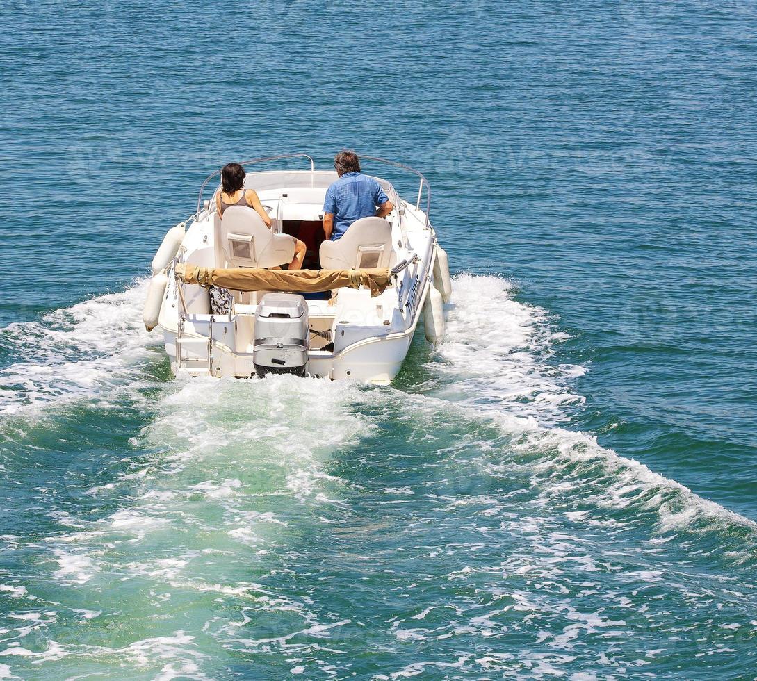 The motor boat with married couple at in sea landscape photo