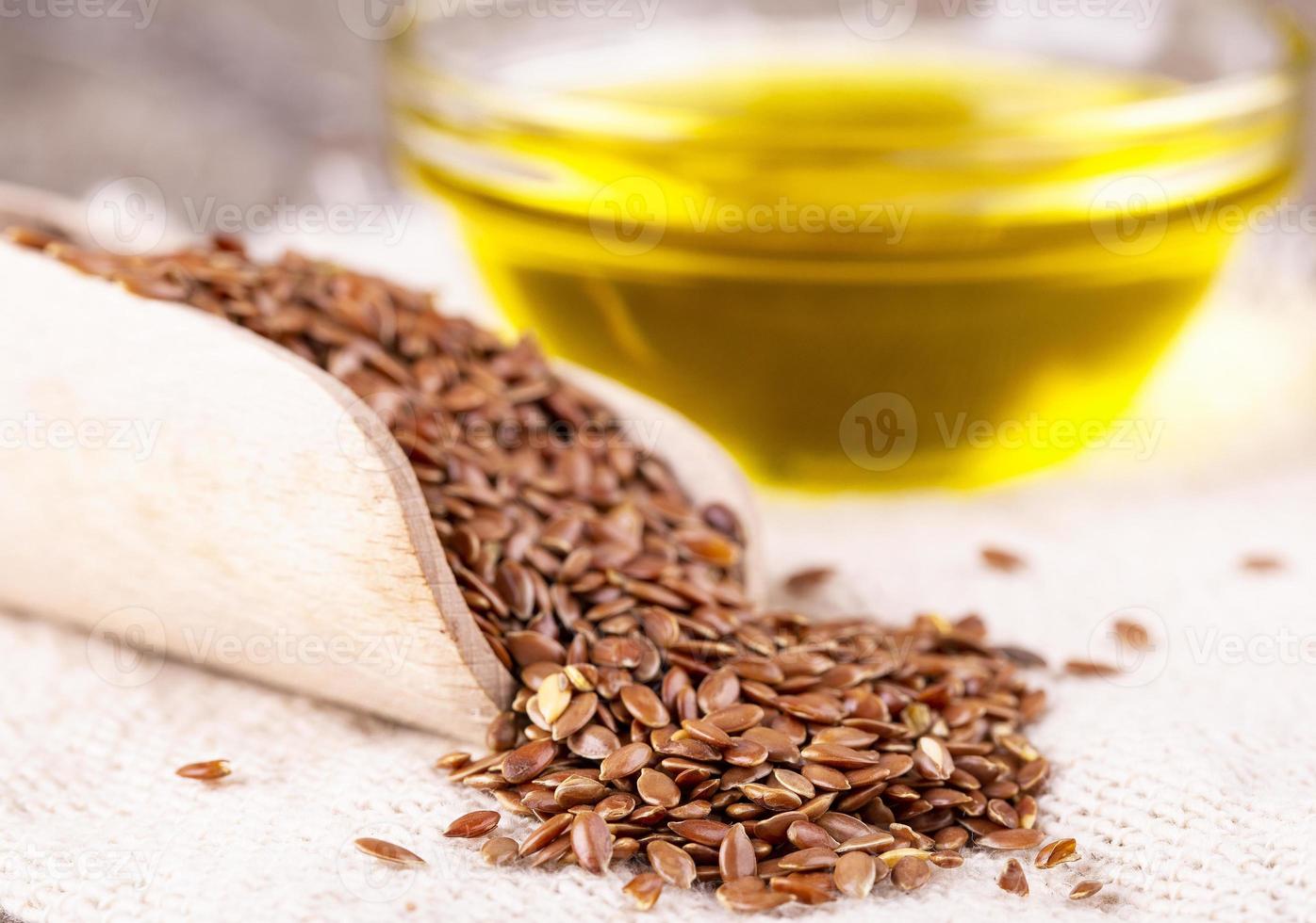 the Brown flax seeds and flaxseed oil on a wooden surface photo