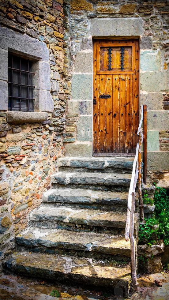 The ancient wooden door and stone staircase photo