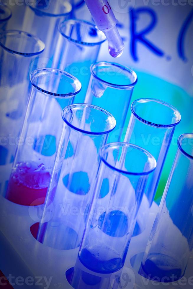 The test tubes and flasks with colored liquid in a laboratory photo