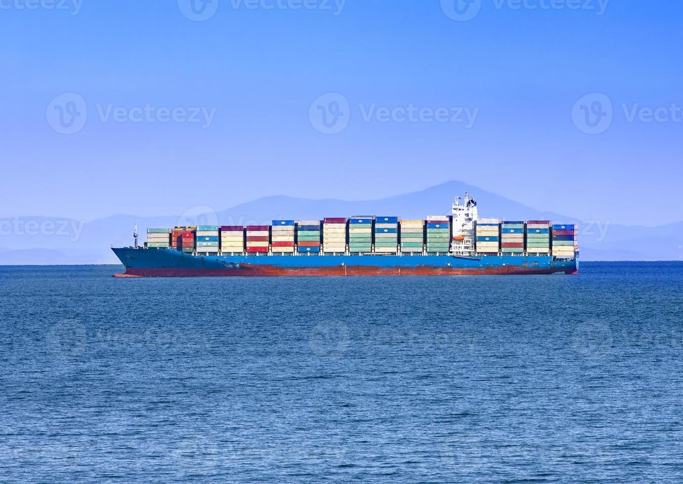 Large container ship at blue sea photo