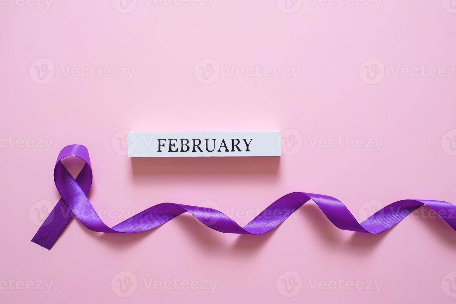 Purple ribbon as symbol of World Cancer Day concept photo