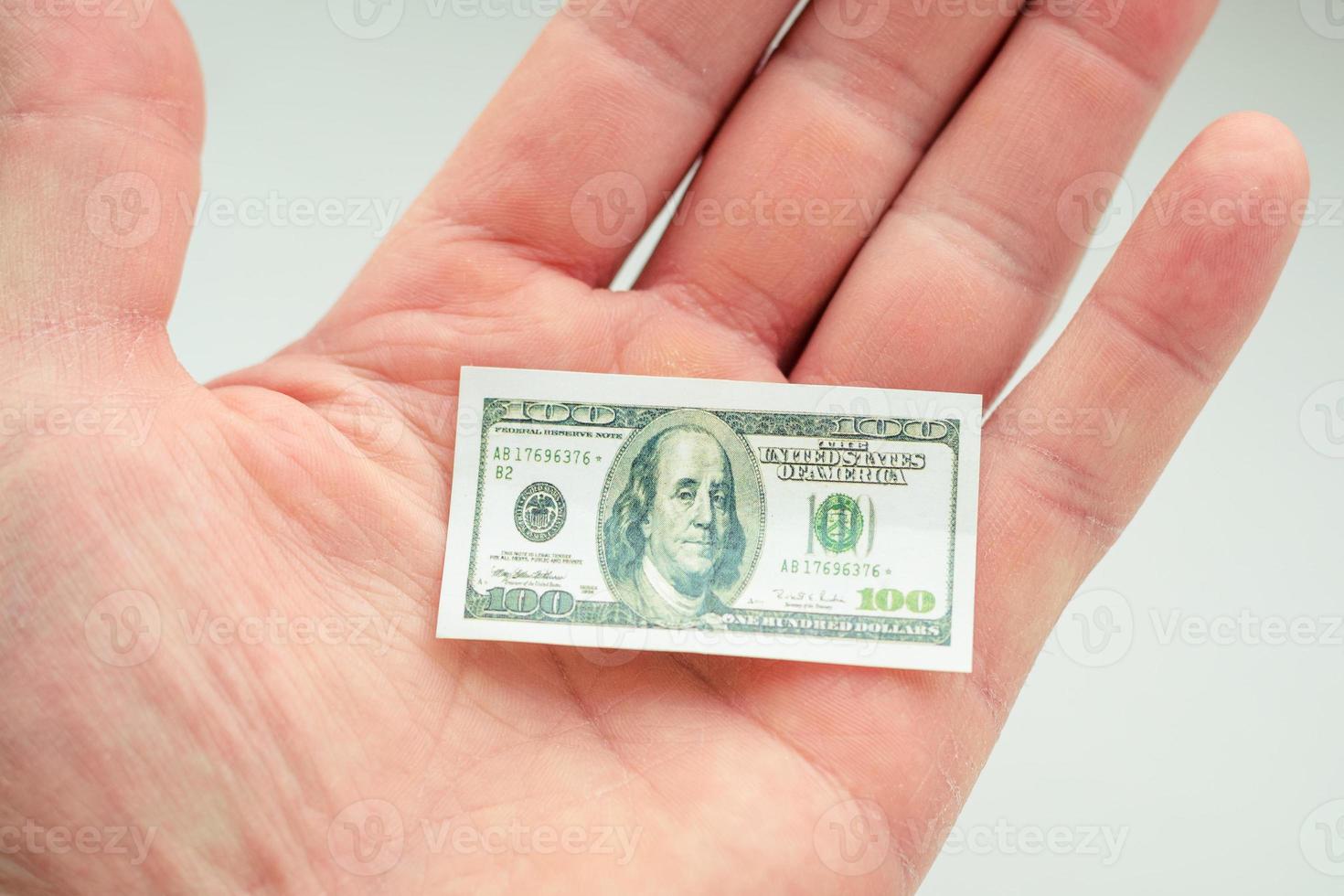 hand holding small banknote of US dollar photo