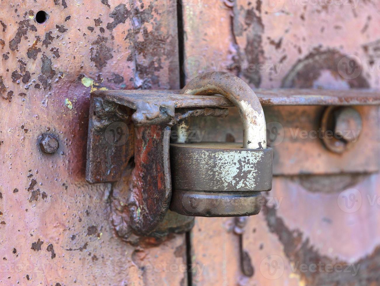 The padlock on the door. Rusty gate photo