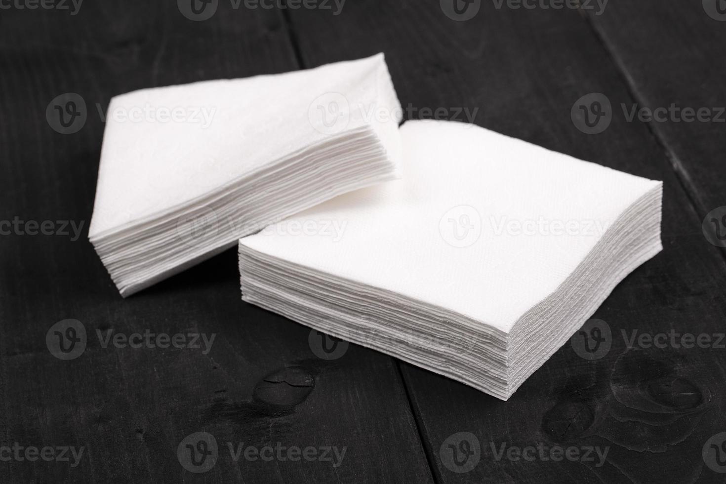 The white paper napkins on wooden background photo