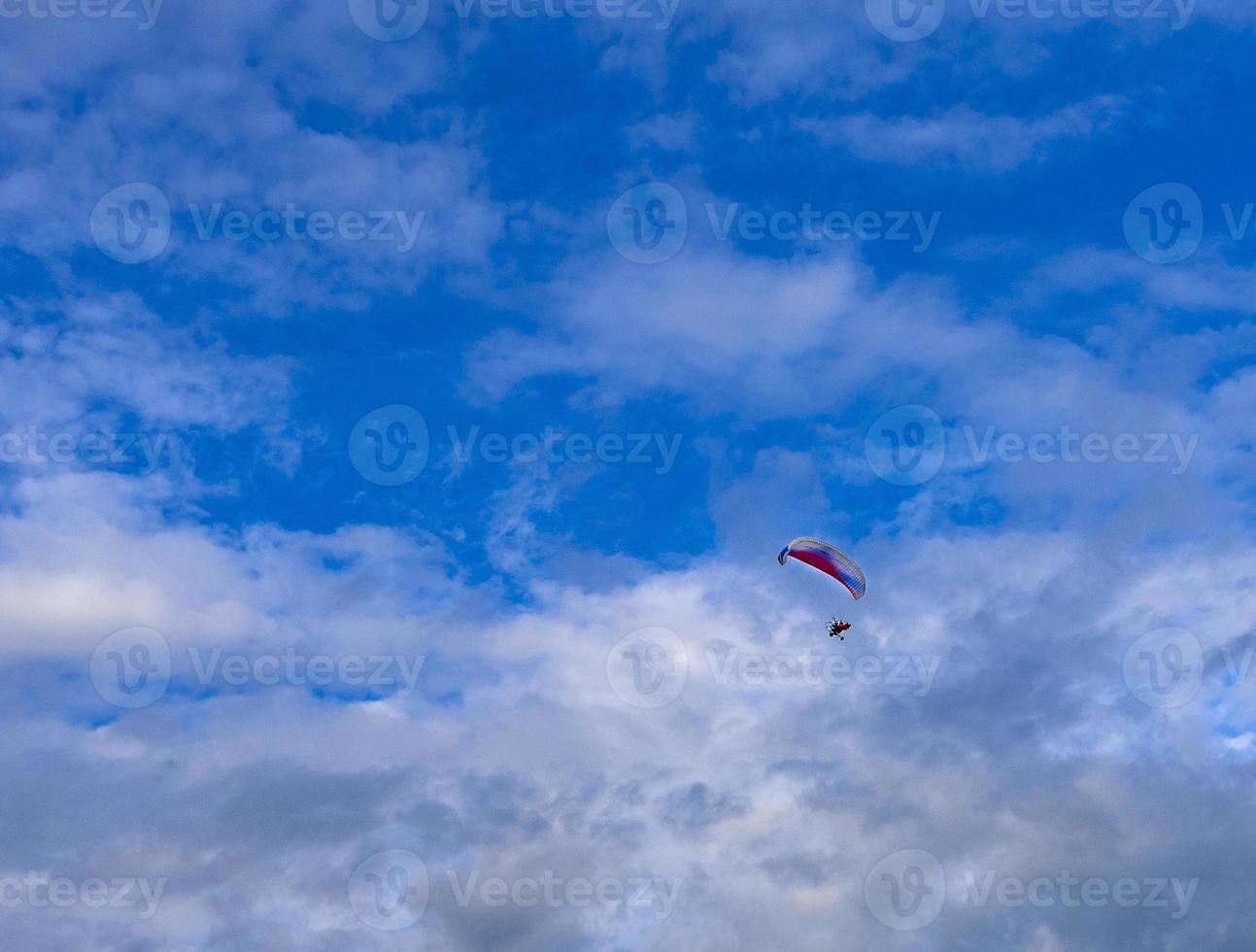 The Paragliders with engine with blue sky background photo