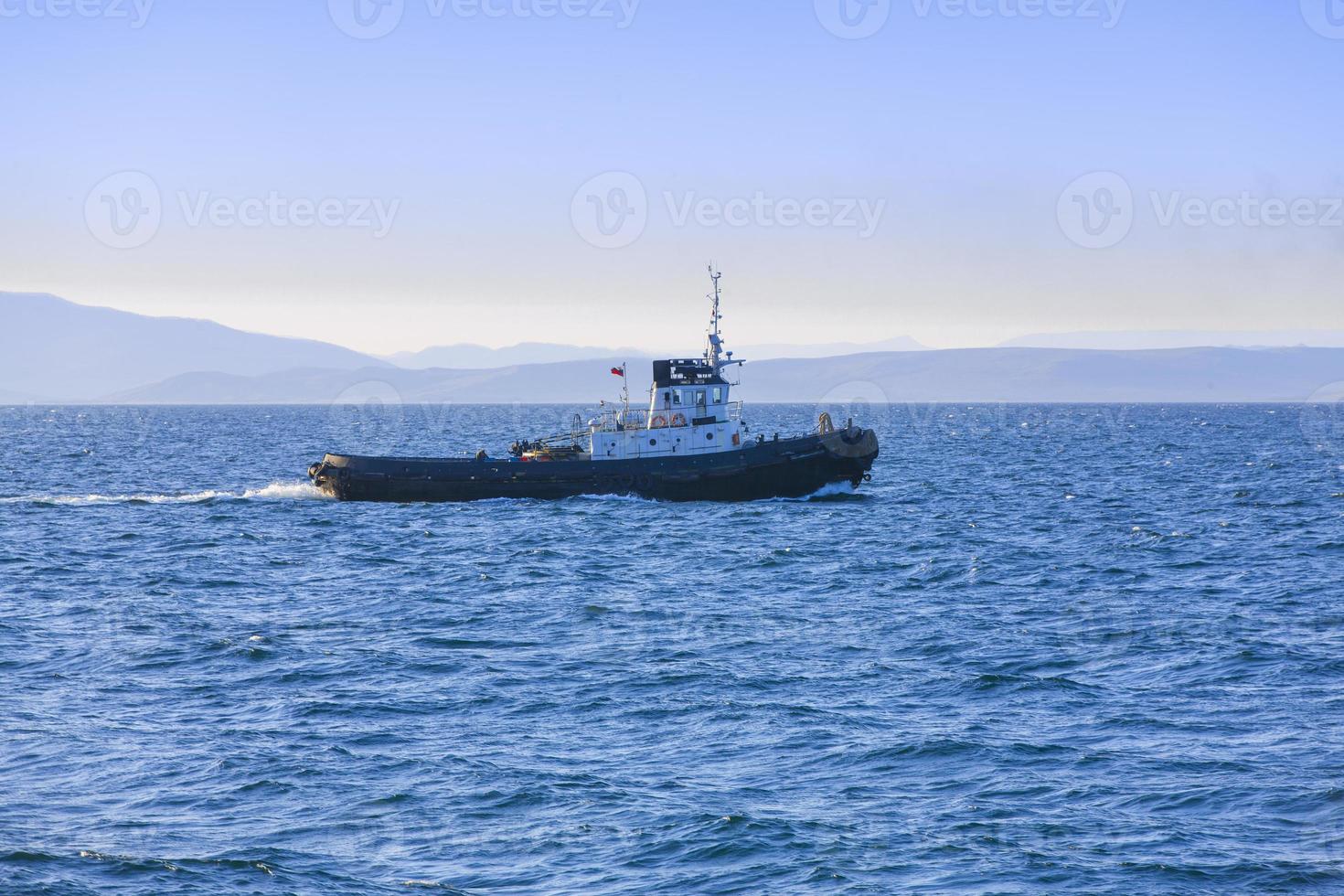 Thre View of a small tugboat in the sea photo