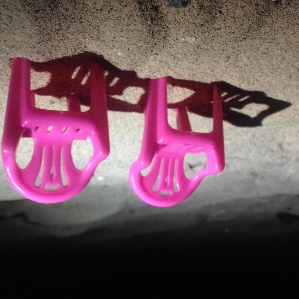 miniature pink chairs on the beach sand photo