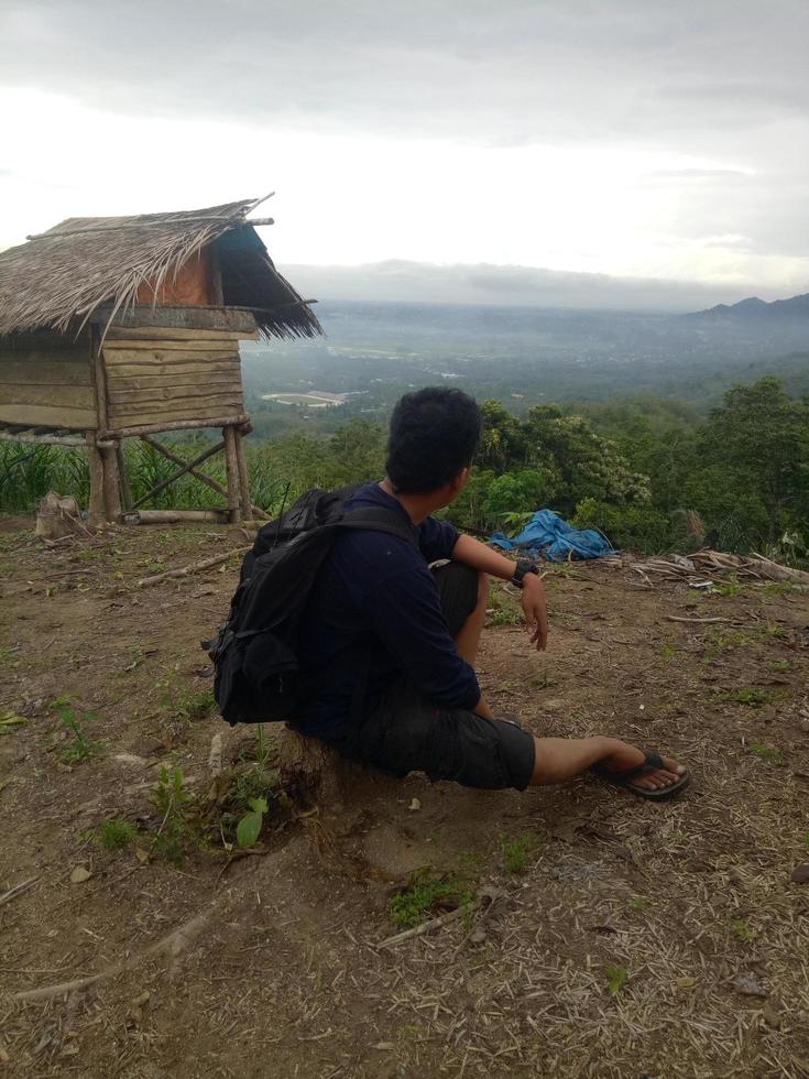 Man hiking in mountains. Travel Lifestyle adventure concept. Beautiful sky with clouds landscape. photo