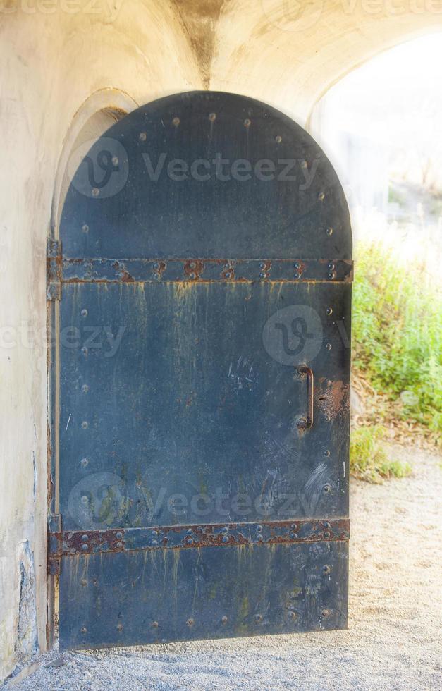 old opened metal door in a medieval castle close up photo