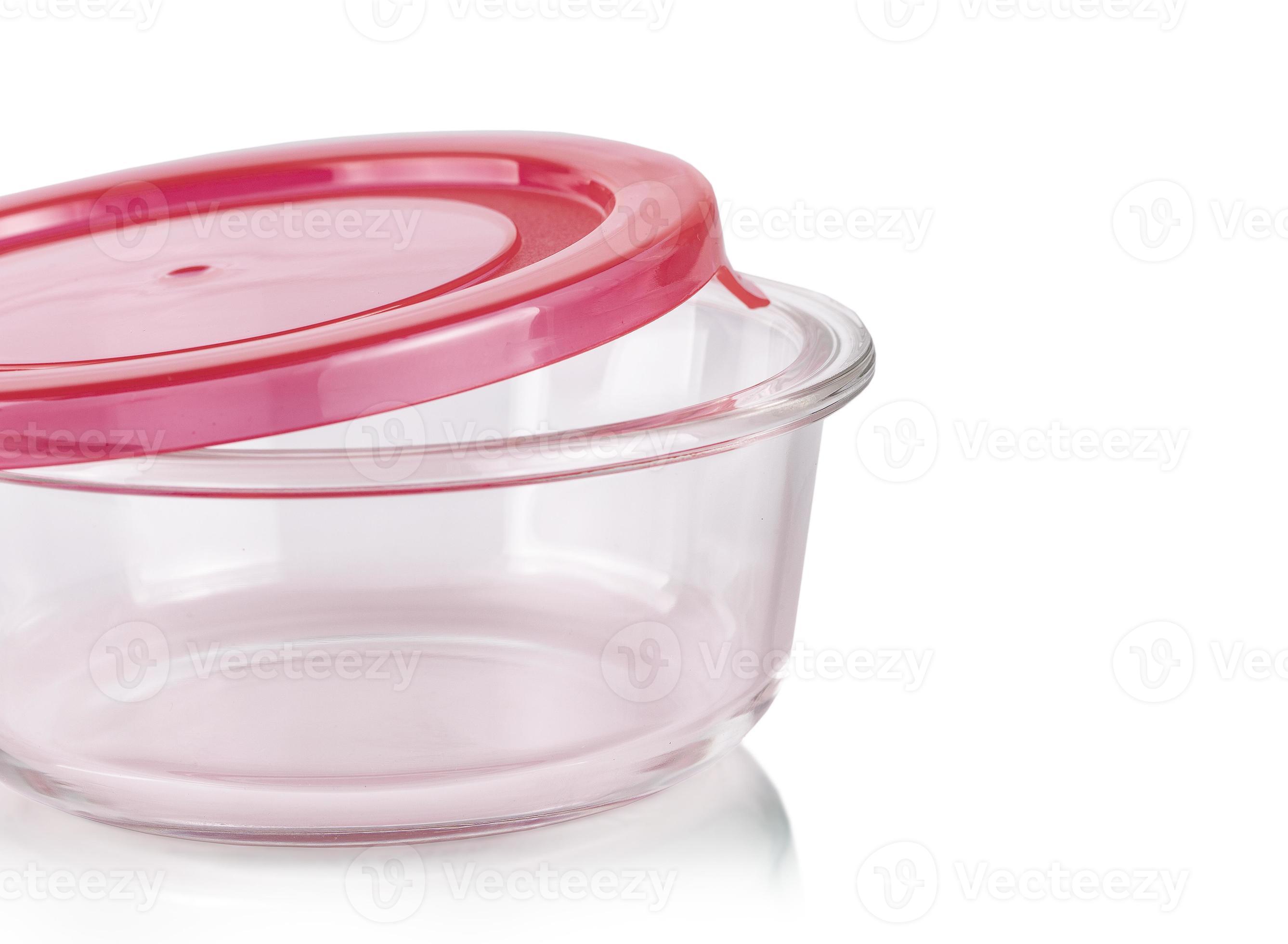 The glass food container with red plastic lid isolated on white