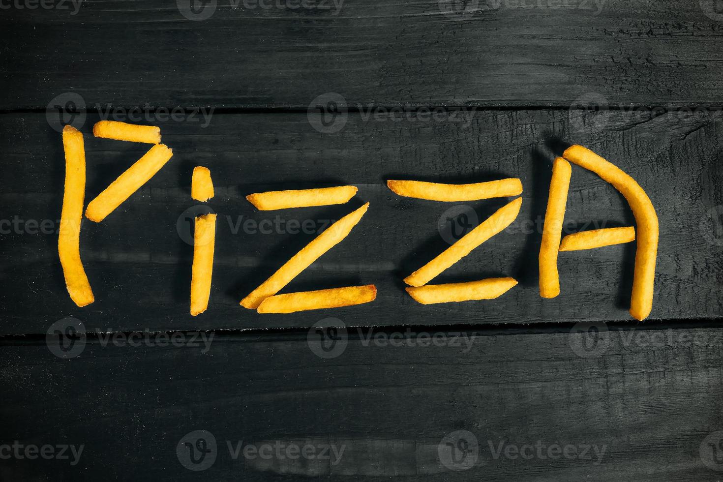 the inscription pizza made of French fries photo