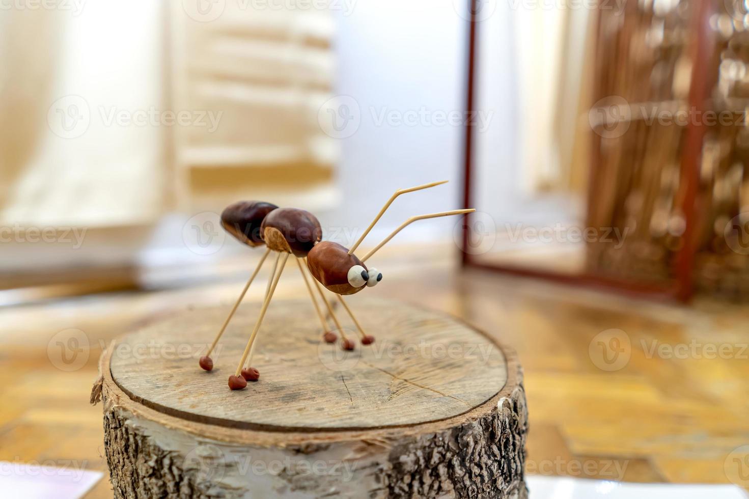 an ant figurine made of chestnuts close-up photo