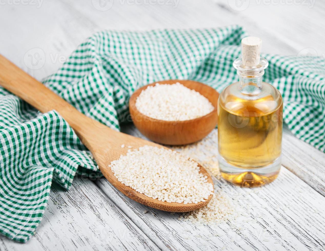 Sesame seeds and bottle with oil photo